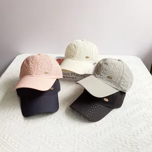 Detail view of five breathable laser-cut baseball caps in pastel and neutral colors