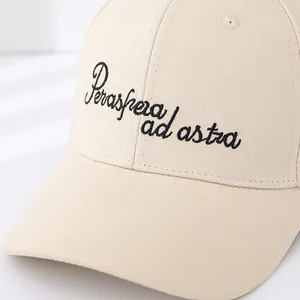 Close-up of beige twill cotton baseball cap with black Per aspera ad astra embroidery