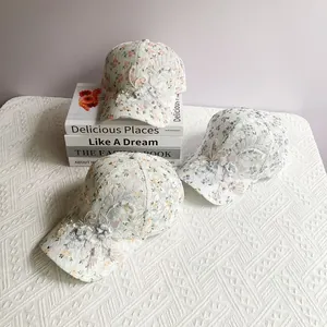 Detail of floral lace baseball cap with handmade 3D iris embroidery and pearl accents