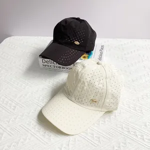 Lightweight quick-dry baseball caps in black and cream with breathable laser-cut holes