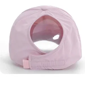 Detail of pink ponytail baseball cap with large back opening and velcro strap closure