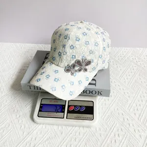 Close-up of lightweight lace baseball cap featuring rhinestone butterfly and 72g weight