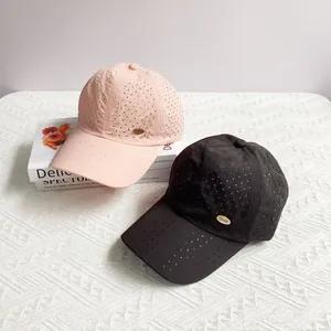 Lightweight breathable baseball caps with gold metal logo in pink and black colors