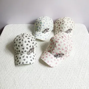 Close-up of breathable lace baseball caps with rhinestone butterfly and geometric patterns