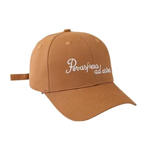 Classic tan cotton baseball cap with white script embroidery on white background