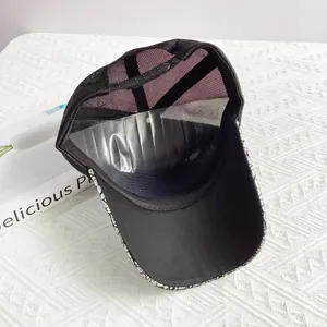 Breathable black mesh trucker hat featuring a cracked pattern brim and ventilated back