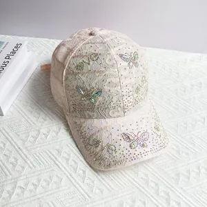 Detail of pink lace baseball cap with rhinestone butterfly and LOVE lettering