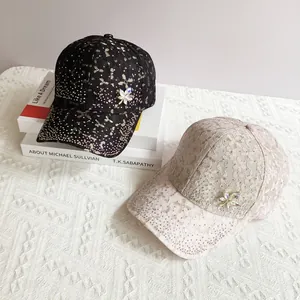 Detailed view of fashion baseball hats with lace fabric, sequins and maple leaf crystal brooch