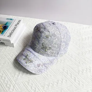 Detail of lavender lace baseball cap featuring shimmering rhinestone butterflies and crystals
