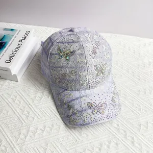 Detail of light purple lace baseball cap with sparkling rhinestone butterfly patterns