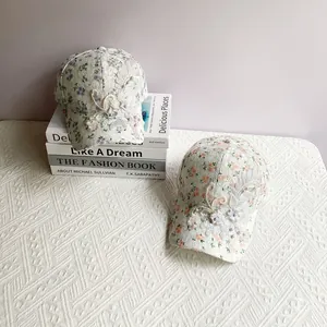 Detail of lace floral baseball caps with 3D flower embroidery and pearl accents