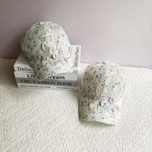 Close-up of floral lace baseball cap with 3D iris embroidery and pearl accents