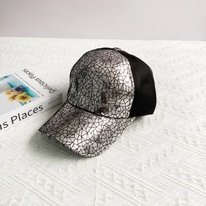 Detail of silver geometric cracked pattern and black mesh on a hip-hop baseball cap