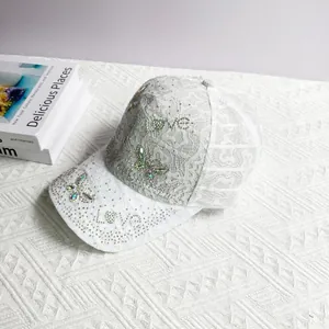 Close-up of lace baseball cap with colorful rhinestone LOVE and butterfly design