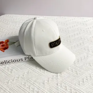 Detail of white baseball cap with crystal mumu letter patch and adjustable strap back