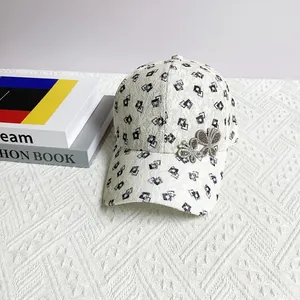 Detailed close-up of a lace baseball cap featuring a decorative rhinestone butterfly