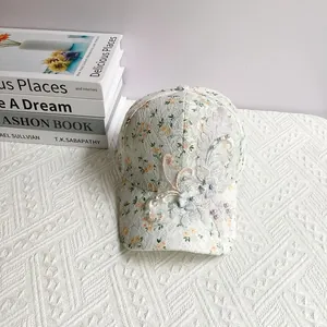 Detailed shot of lace floral baseball cap with 3D flower applique and small pearls