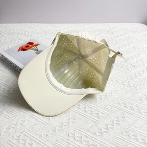Interior detail of lightweight breathable baseball cap showing laser-cut holes and strap