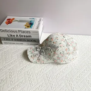Close-up of lace baseball cap with floral print, 3D embroidery and pearl details