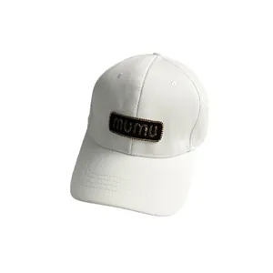 White cotton baseball cap featuring black mumu label embroidery and a curved brim