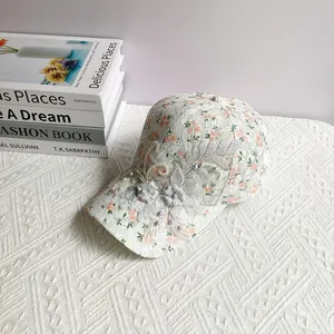 Detailed embroidery of purple flowers and pearls on floral lace baseball cap