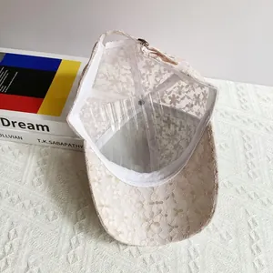 Detailed view of beige floral lace mesh fabric on a breathable baseball cap