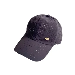 Navy blue breathable quick-dry baseball cap with laser-cut holes and gold metal logo