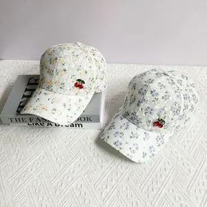 Lace baseball caps with floral patterns and cherry charms in yellow and purple