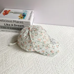 Close-up of floral lace baseball cap with pearl accents and 3D flower detail