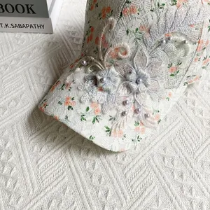 Detail of floral lace baseball cap with 3D flower embroidery and purple pearls