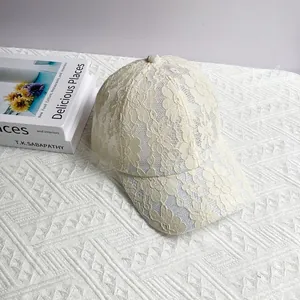 Gros plan détaillé de la casquette beige en dentelle avec broderies florales fines