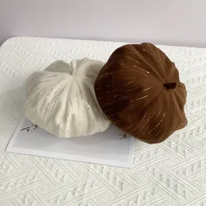 Detail of wool beret hats with sparkling rhinestone vertical stripes in beige and brown