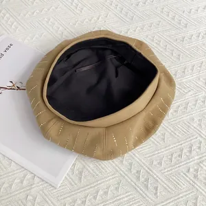 Close-up of wool octagonal beret with vertical rhinestones and adjustable inner drawstring