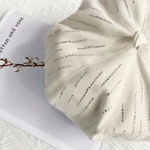 Detailed close-up of cream wool octagonal beret featuring vertical rhinestone stripes