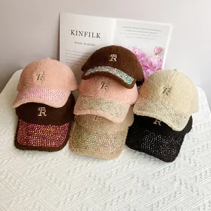 Detail of lamb wool baseball cap featuring rhinestone-encrusted brim and metal R letter