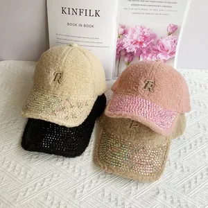 Detailed view of lamb wool baseball caps with rhinestone brims and metallic R letter logo