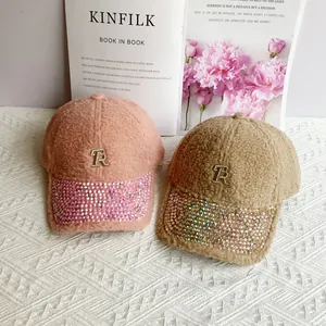 Detail of plush sherpa baseball caps with TR metal logo and iridescent rhinestone brim