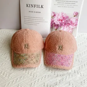 Detailed view of lamb wool baseball caps with rhinestone brims and metal TR logo