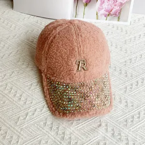 Detailed view of pink lamb wool cap with rhinestone brim and letter R embroidery
