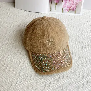 Detailed shot of camel fleece baseball cap featuring colorful rhinestones and TR embroidery