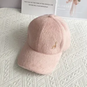 Detail of light pink plush baseball cap with sparkling crystal swan ornament