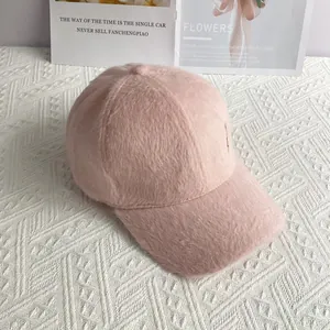 Detailed texture of pink faux fur baseball cap with subtle silver glitter and gold accent