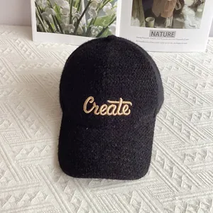 Dettaglio del berretto da baseball in ciniglia nera con ricamo Create e filato luccicante