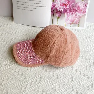 Detailed view of pink lamb wool baseball cap featuring sparkling rhinestones on the brim