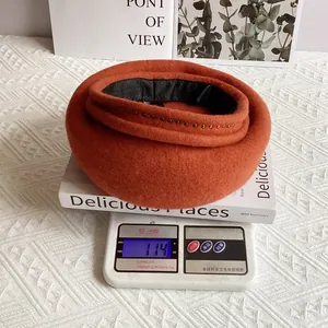 Detailed view of caramel wool beret with metal rivets showing 114g weight on scale