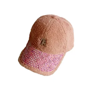 Pink sherpa baseball cap with rhinestone brim and metallic R letter logo detail
