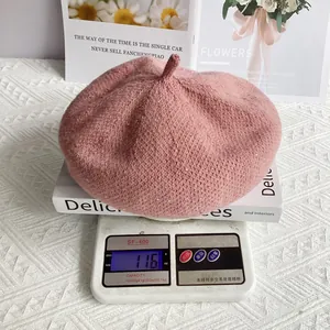 Detail shot of light pink sequin chenille knit beret on scale showing 116g weight