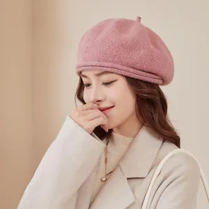 Detail of pink chenille knit beret with subtle sequins on a warm beige background