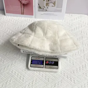 Detail of white faux fur bucket hat with embossed grid pattern on a weighing scale