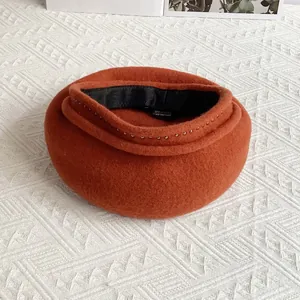 Macro view of wool beret showing inner lining and silver bead trim details